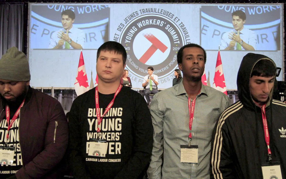 Protesters turn their backs on Prime Minister Justin Trudeau as he addresses the Canadian Labour Congress National Young Workers' Summit in Ottawa on Tuesday October 25, 2016. THE CANADIAN PRESS/Fred Chartrand