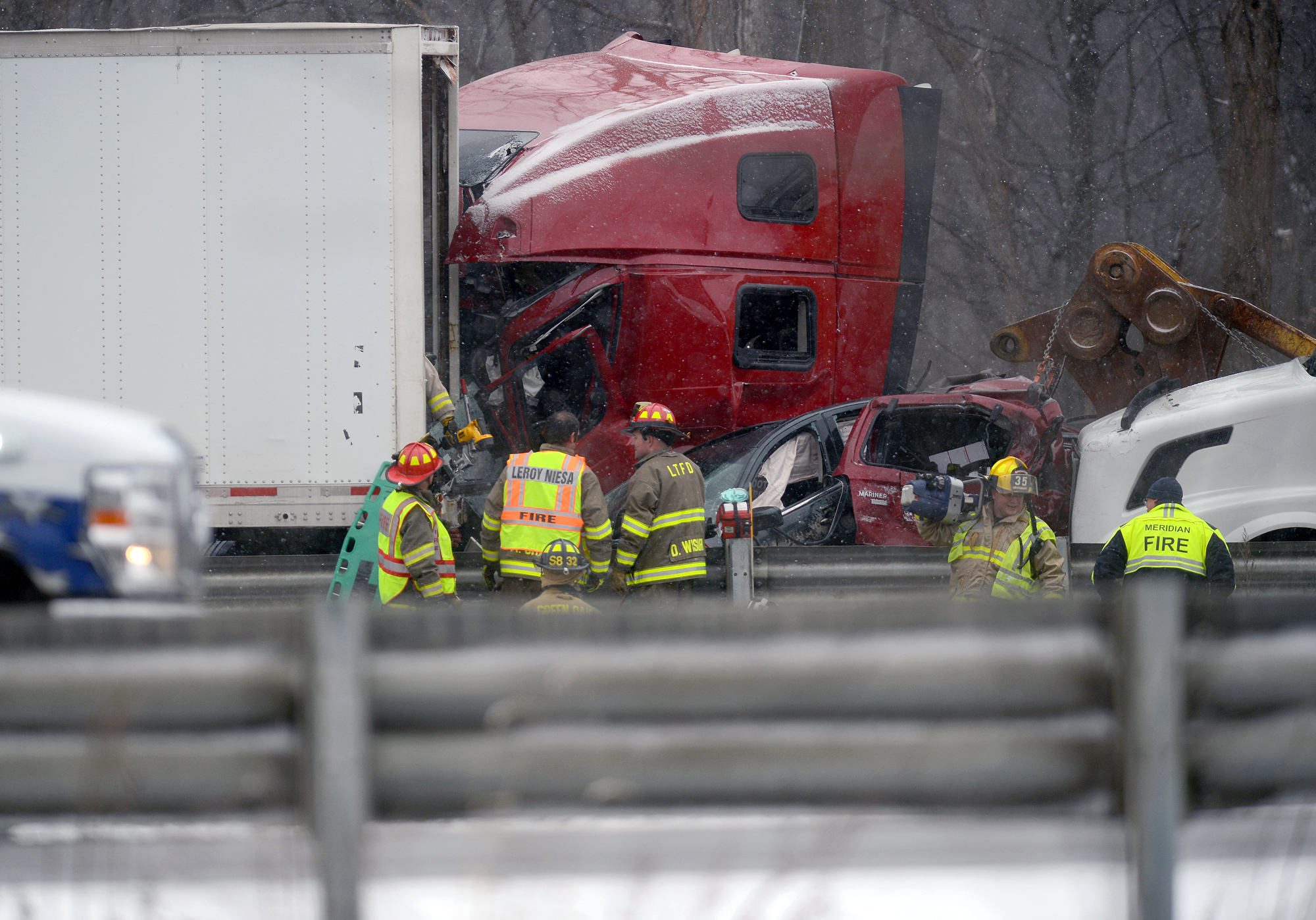 Emergency crews work the scene of a multiple car pileup on I-96 between Webberville and Fowlerville, Mich., on Dec. 8, 2016. (Dave Wasinger/Lansing State Journal via AP)