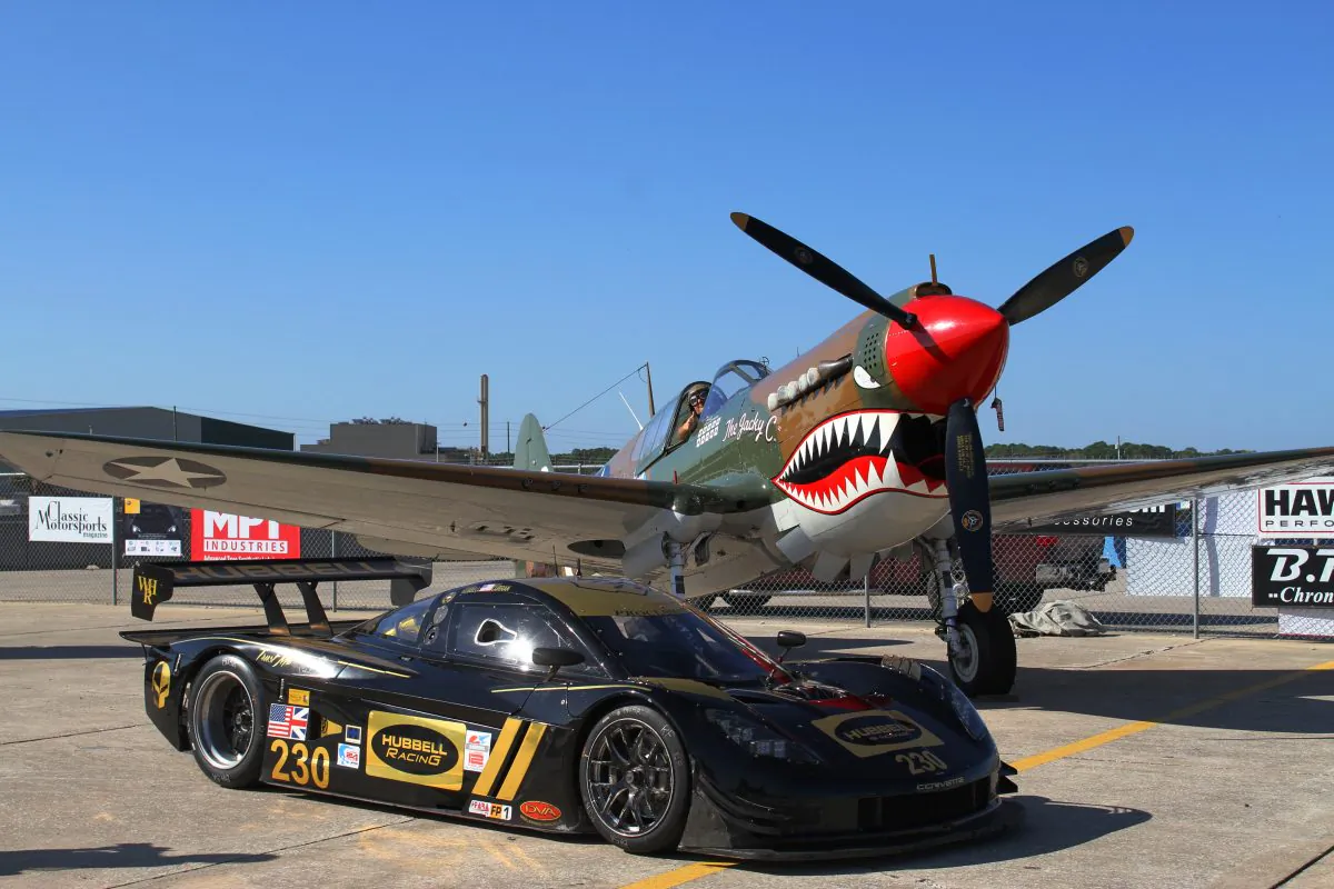 Two of the stars of the HSR Classic 12 Hour at Sebring Pistons and Props, a P-51 Mustang fighter and the #230 Coyote-Corvette, Dec. 1–4, 2016. (Chris Jasurek/Epoch Times)