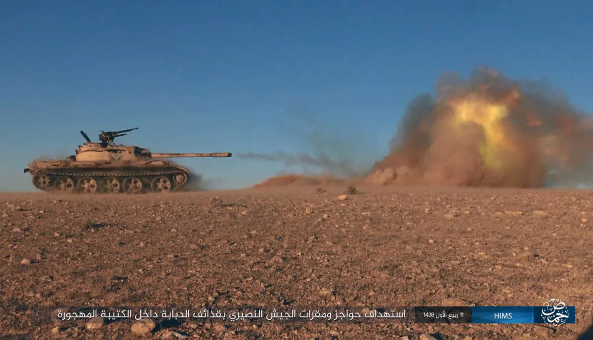 This image posted online on Dec. 10, 2016, by supporters of the ISIS on an anonymous photo sharing website, purports to show a tank operated by the group firing at Syrian troops east of Palmyra city, in Homs provence, Syria. (Militant Photo via AP)