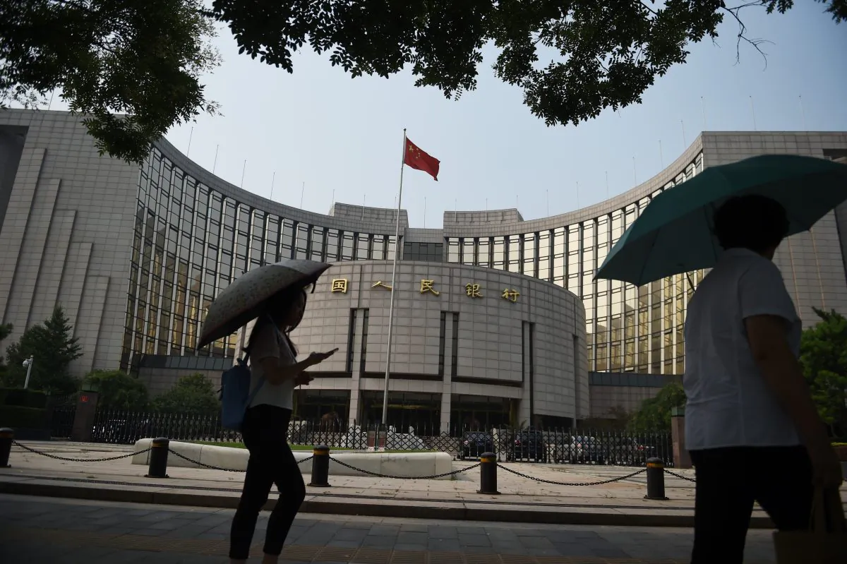 Pedestrians walk past the People's Bank of China, the central bank of China, in Beijing July 8, 2015. (Greg Baker/AFP/Getty Images)
