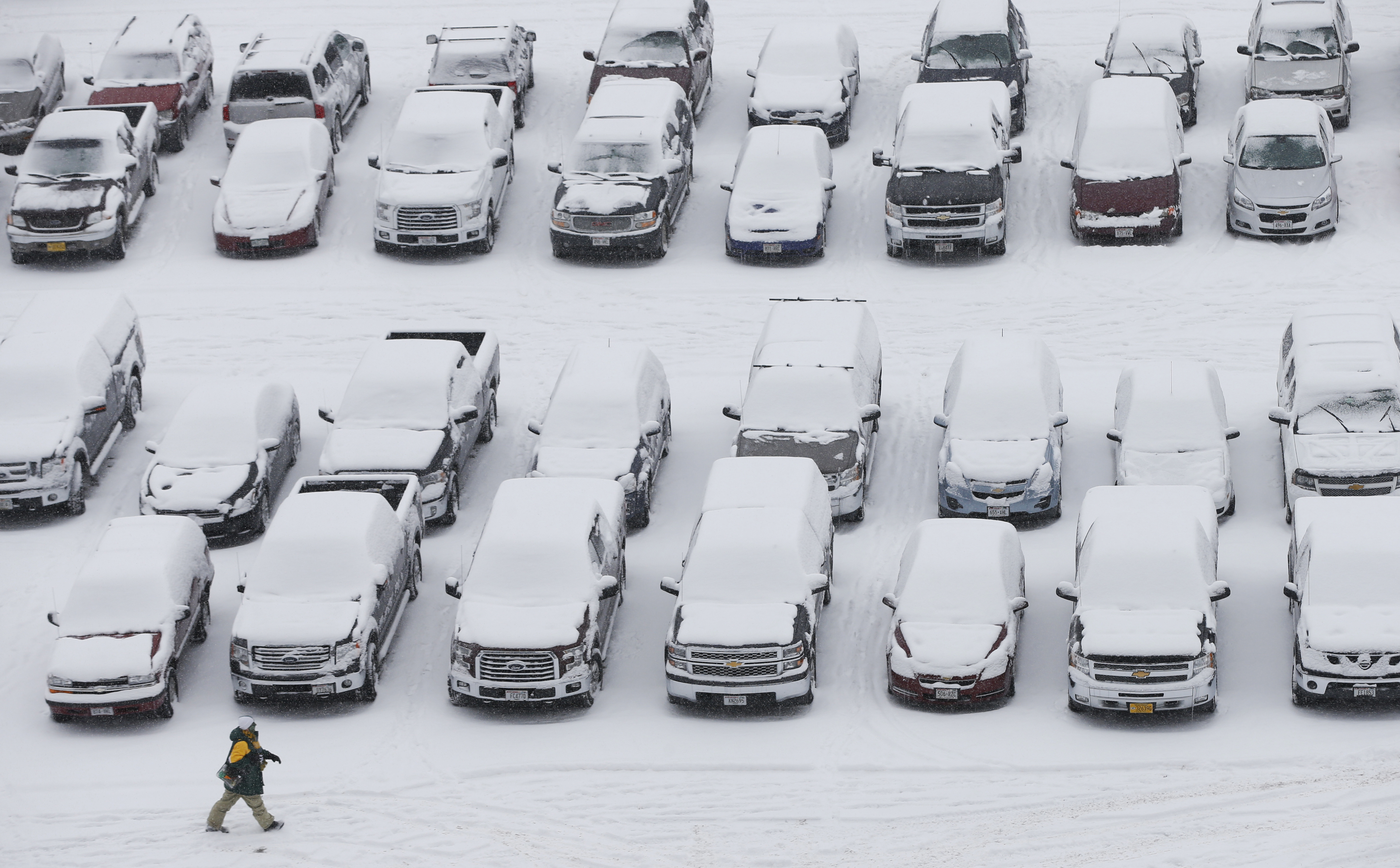 A fan makes his way to Lambeau Field in the snow before an NFL football game between the Green Bay Packers and the Seattle Seahawks in Green Bay, Wis., on Dec. 11, 2016. (AP Photo/Mike Roemer)