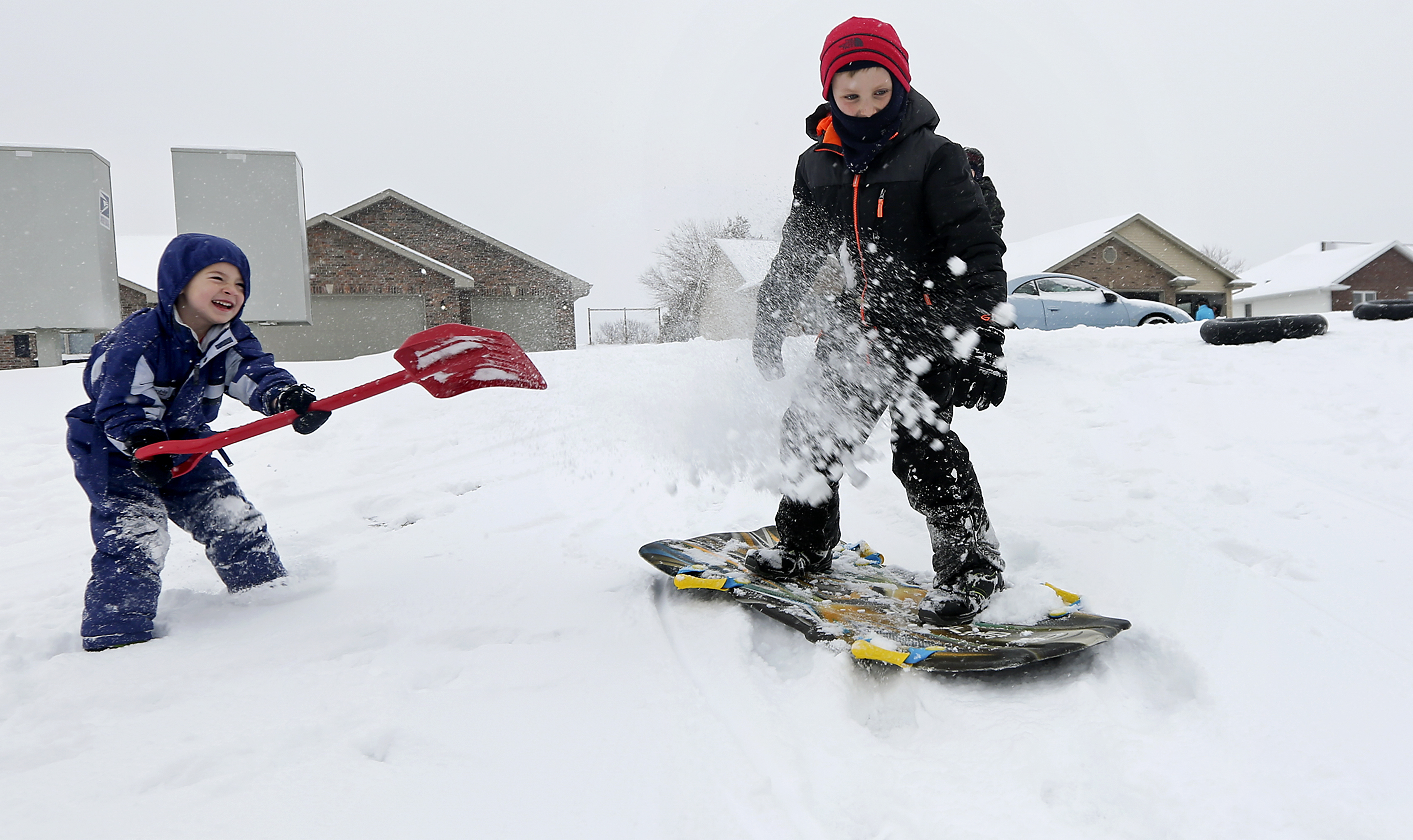 Children play in the snow in Asbury, Iowa, on Dec. 11, 2016. (Nicki Kohl/Telegraph Herald via AP)