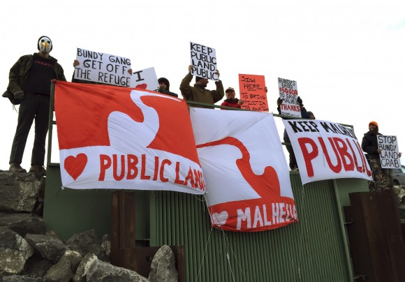 In the Jan. 23, 2016, file photo, demonstrators gather near a national wildlife refuge to protest against a group occupying the land near in Burns, Ore. Some conservatives have long believed federal managers of America's vast public lands put more value on endangered owls than people and jobs. (AP Photo/Keith Ridler, File)