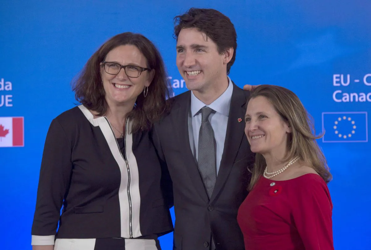 Prime Minister Justin Trudeau with International Trade Minister Chrystia Freeland (R) and EU Commissioner Cecilia Maelstrom following the signing of the Comprehensive Economic and Trade Agreement signing ceremony at the Council of the European Union in Brussels, Belgium, on Oct. 30, 2016. (The Canadian Press/Adrian Wyld)