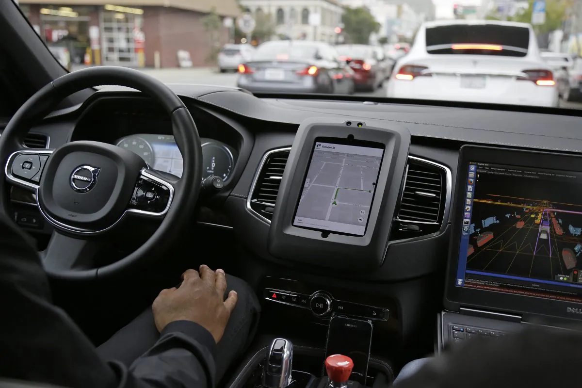 An Uber driverless car waits in traffic during a test drive in San Francisco, Dec. 13, 2016. (AP Photo/Eric Risberg)