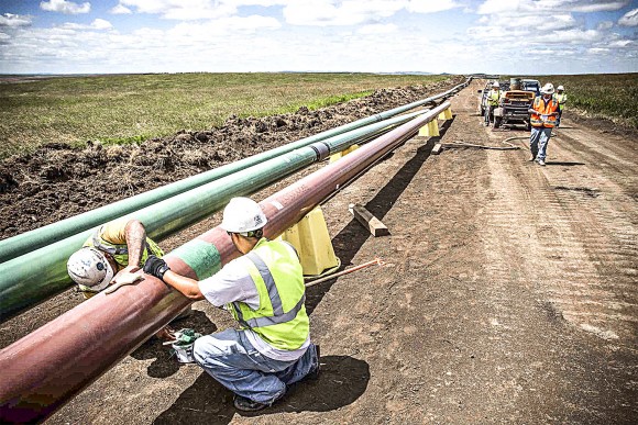 Construction workers on a section of the Dakota Access Pipeline outside Watford City, N.D., on July 25, 2013. (Andrew Burton/Getty Images)