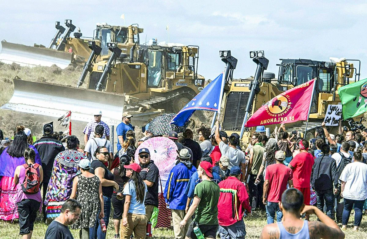 Members of the Standing Rock Sioux Tribe and their supporters confront bulldozers working on the Dakota Access Pipeline near Cannon Ball, N.D., on Sept. 3. (ROBYN BECK/AFP/Getty Images)