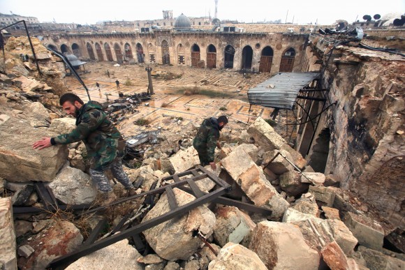 A general view shows Syrian pro-government forces walking in the ancient Umayyad mosque in the old city of Aleppo after they captured the area on Dec. 13, 2016. After weeks of heavy fighting, regime forces were poised to take full control of Aleppo, dealing the biggest blow to Syria's rebellion in more than five years of civil war. (YOUSSEF KARWASHAN/AFP/Getty Images)