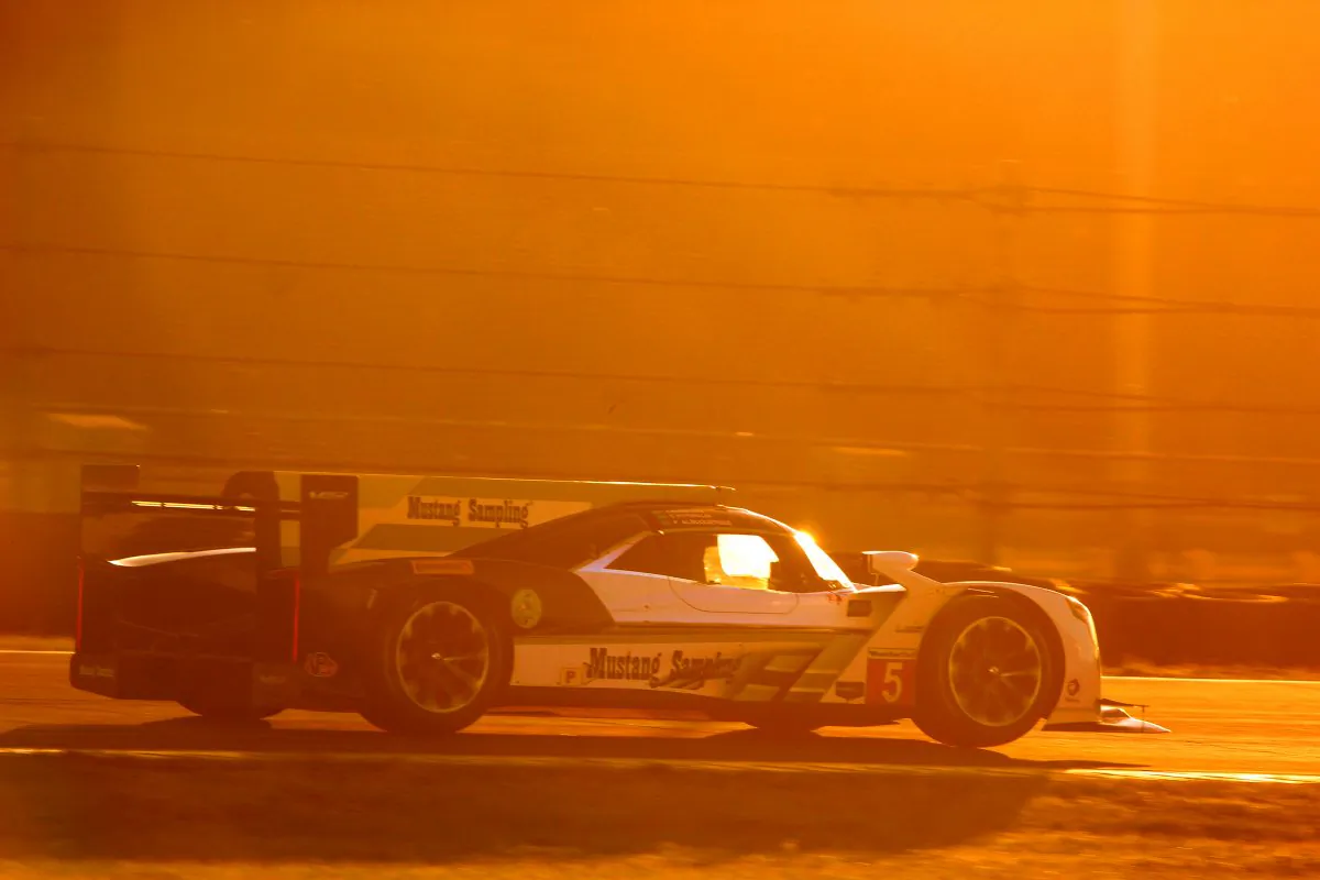 The #5 Action Express Racing Cadillac DPi V.R. is scorched by the sun setting over Daytona’s West Horseshoe. (Chris Jasurek/Epoch Times)