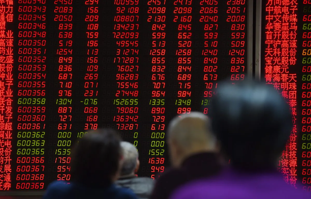 Investors watch price movements on screens in Beijing Feb. 22. China's insurance regulator said risky stock market bets by domestic insurers undermines market stability. (Greg Baker/AFP/Getty Images)