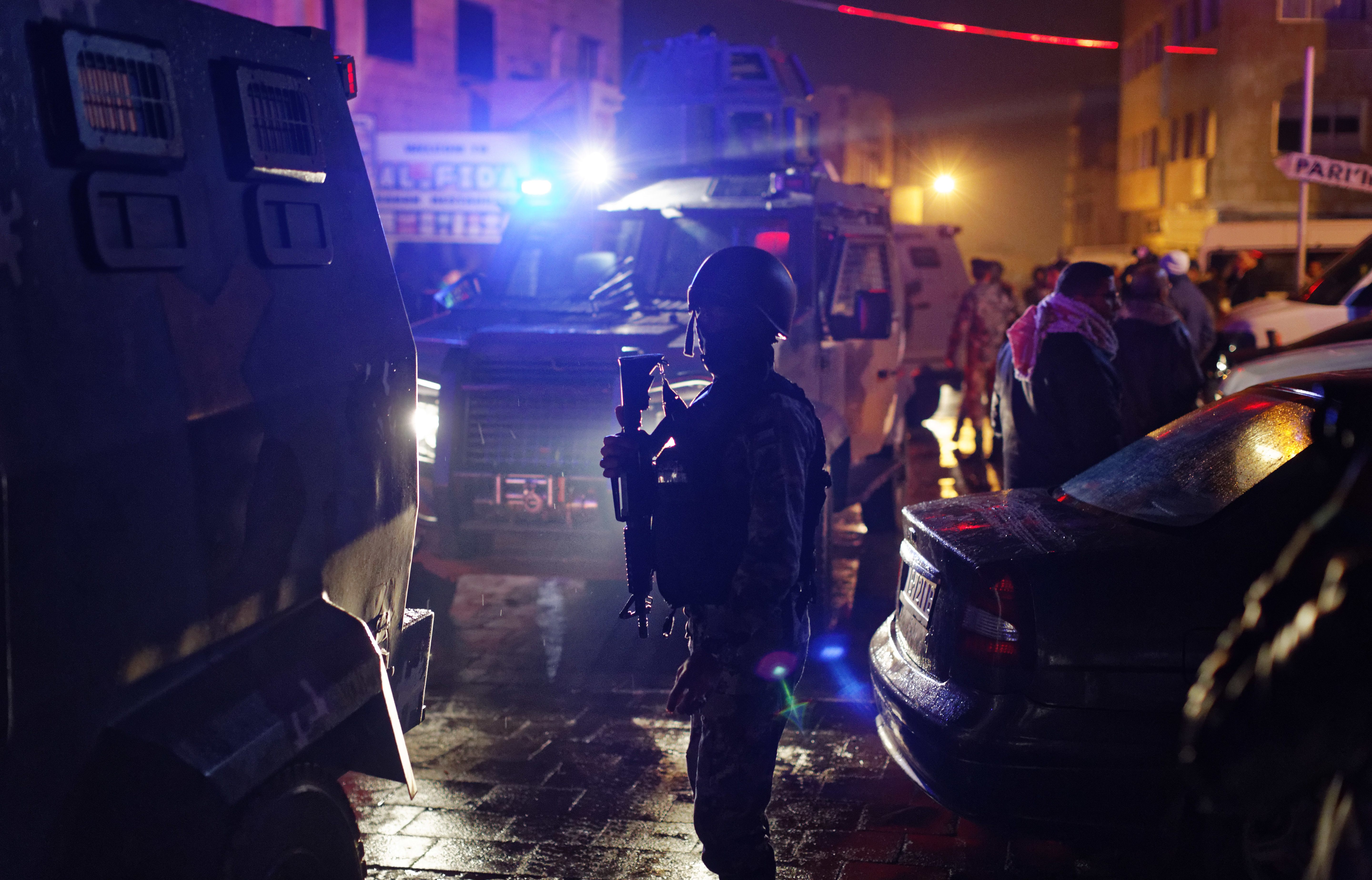 Jordanian security forces stand next to their armored vehicles at the scene next to Karak Castle, during an ongoing attack, in the central town of Karak, about 140 kilometers (87 miles) south of the capital Amman in Jordan on Dec.18, 2016. (AP Photo/Ben Curtis)