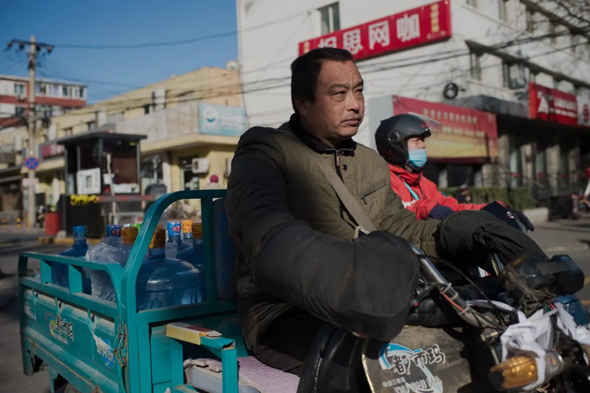 A water container delivery worker drives on a street in Beijing on Dec. 9, 2016. Economist Ma Guangyuan says that China needs to develop genuine property rights to enhance economic growth. (Nicolas Asfouri/AFP/Getty Images)