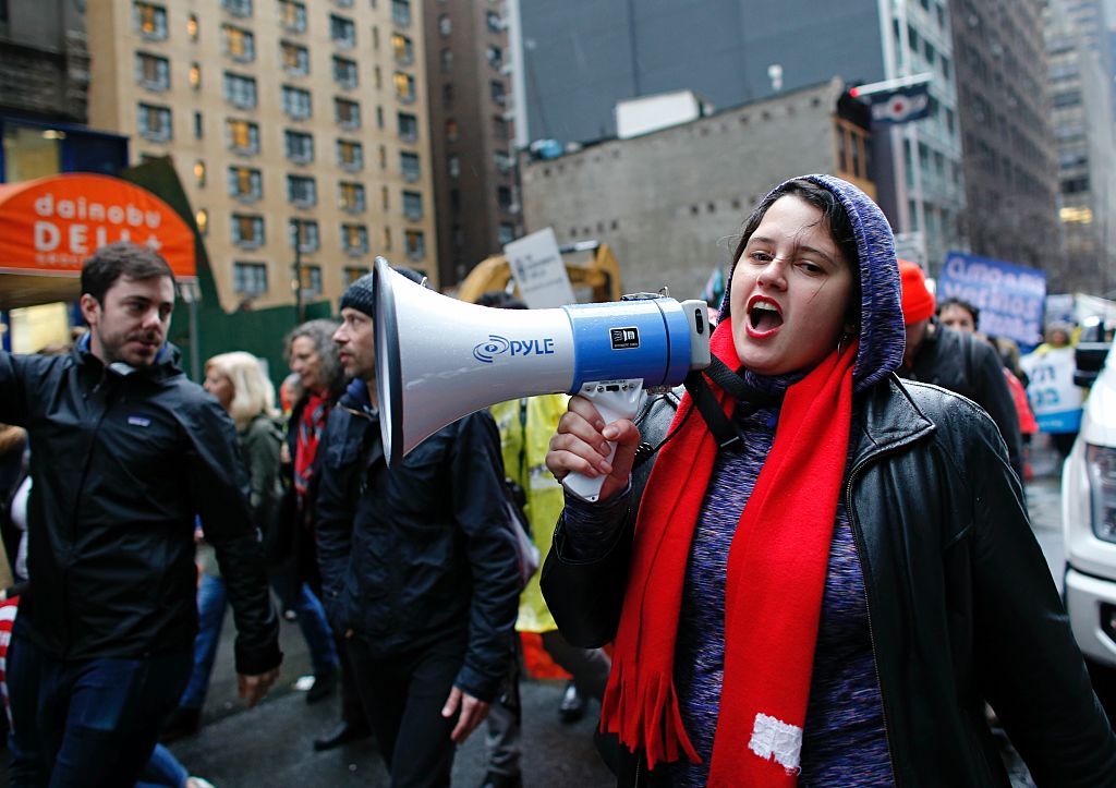 A woman shouts slogans as she attends a protest to mark International Migrants Day while they walk to Trump Tower in New York on Dec. 18, 2016. (KENA BETANCUR/AFP/Getty Images)