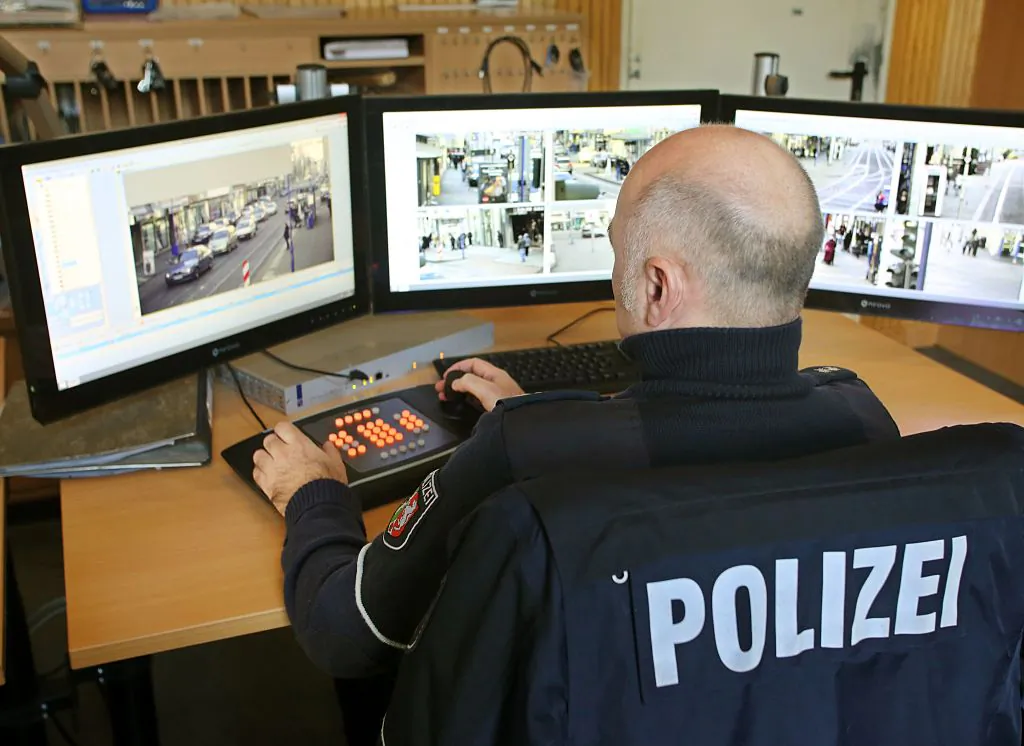 A policeman watches monitors displaying images delivered by surveillance cameras in the Marxloh district of Duisburg, western Germany, on December 21, 2016.
(ROLAND WEIHRAUCH/AFP/Getty Images)