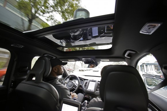 FILE - In this Tuesday, Dec. 13, 2016, file photo, Devin Greene sits in the front seat of an Uber driverless car during a test drive in San Francisco. Uber has pulled its self-driving cars from California roads. The ride-sharing company said Wednesday, Dec. 21, 2016, California transportation regulators revoke registrations for the vehicles. The DMV confirmed that it had moved to revoke the registrations of 16 cars, saying officials had been determined that the registrations were improperly issued because the vehicles were not properly marked as test vehicles. (AP Photo/Eric Risberg, File)