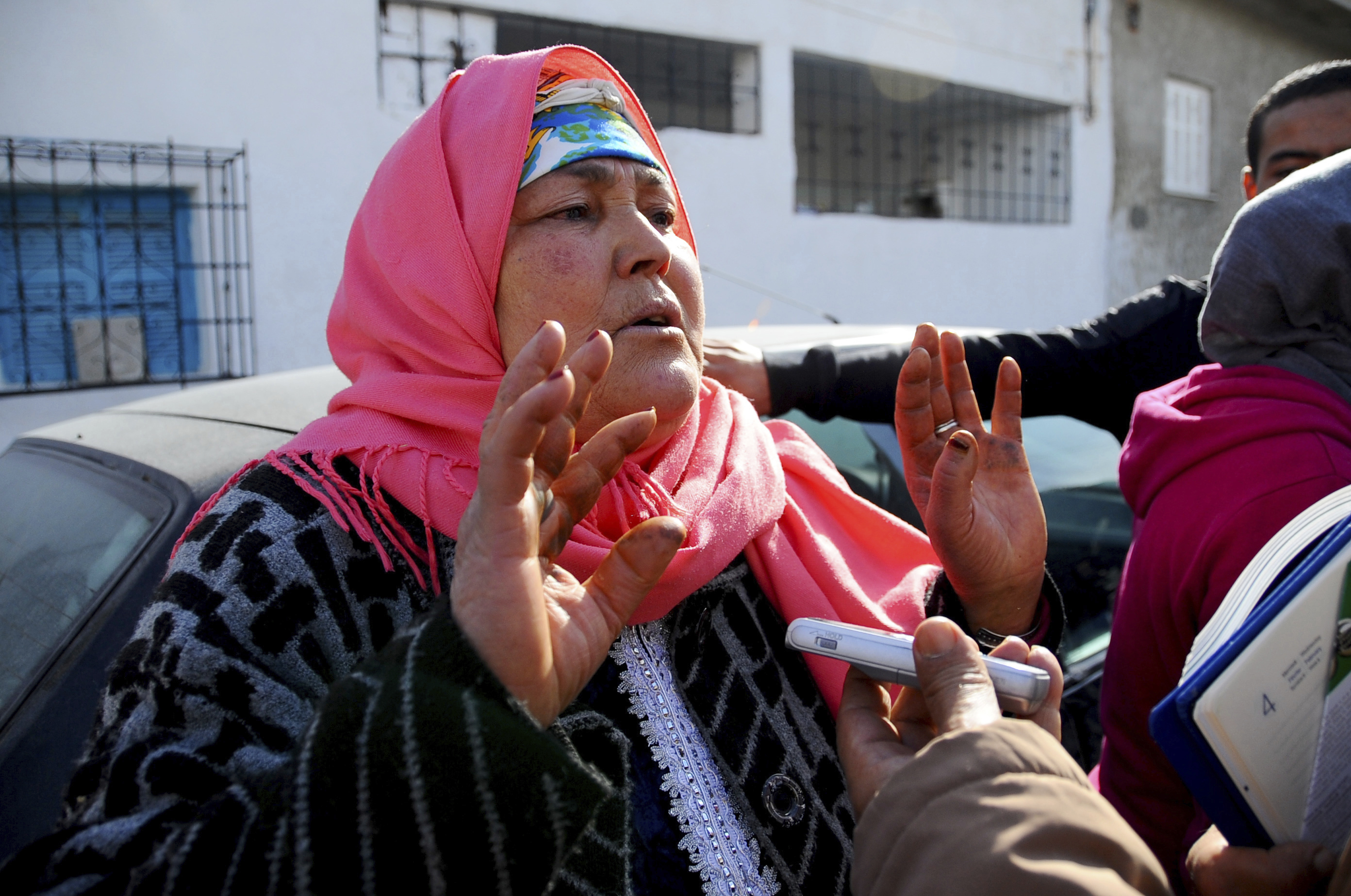 The mother of fugitive Tunisian extremist suspected in Berlin's deadly Christmas market attack, Nour El Houda Hassani, in Oueslatia, central Tunisia, on Dec. 22, 2016. (AP Photo/Riadh Dridi)