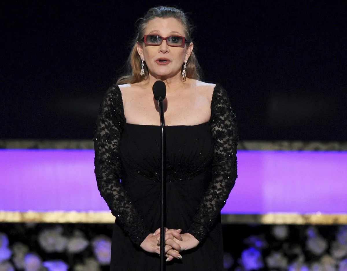 In this Sunday, Jan. 25, 2015 file photo, Carrie Fisher presents the life achievement award on stage at the 21st annual Screen Actors Guild Awards at the Shrine Auditorium in Los Angeles. Fisher has reportedly been transported to a hospital after suffering a severe medical emergency on a flight Friday, Dec. 23, 2016. (Photo by Vince Bucci/Invision/AP, File)