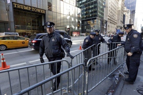 New York City Police adjust barricades across the street from Trump Tower on Fifth Avenue, in New York, Friday, Nov. 11, 2016.  Trump's presidential victory has increasingly turned the streets around his Trump Tower penthouse home into a hardened, national security location.  (AP Photo/Richard Drew)