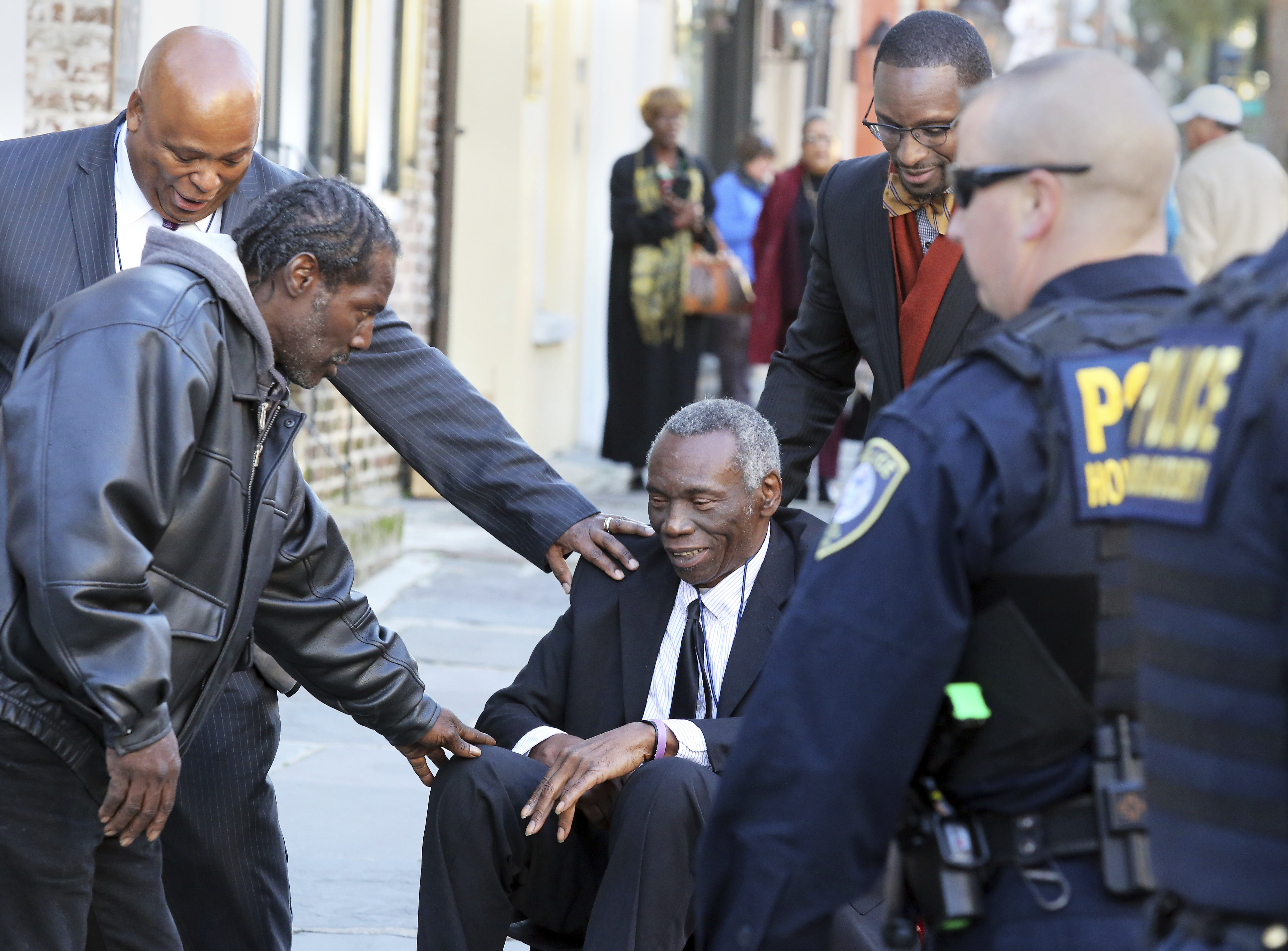 John Pinckney, father of shooting victim Rev. Clementa Pinckney, is greeted after leaving J. Waites Waring Federal Courthouse in Charleston, S.C., on Dec. 15, 2016. (Brad Nettles/The Post And Courier via AP)
