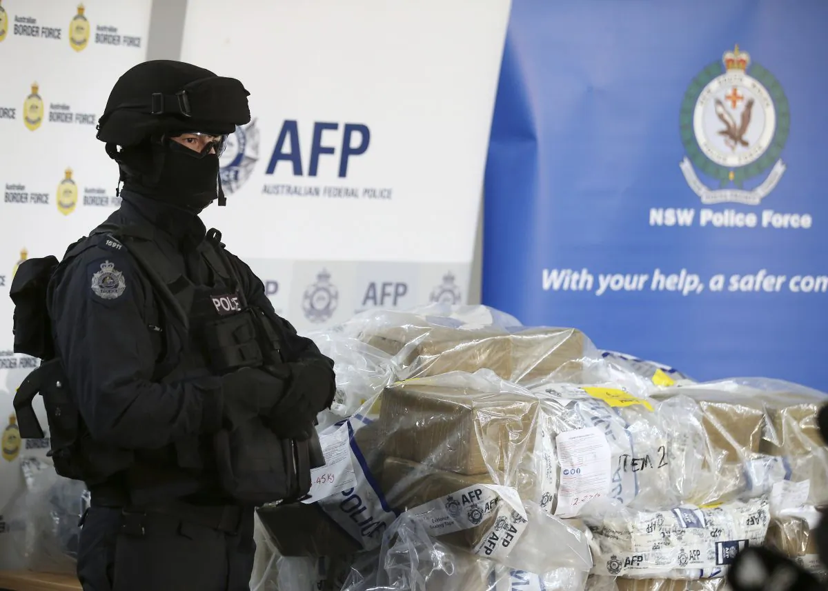 A police officer guards a haul of drugs that are on display at an Australian Federal Police office in Sydney, Australia on Dec. 29, 2016. (AP Photo/Rick Rycroft)