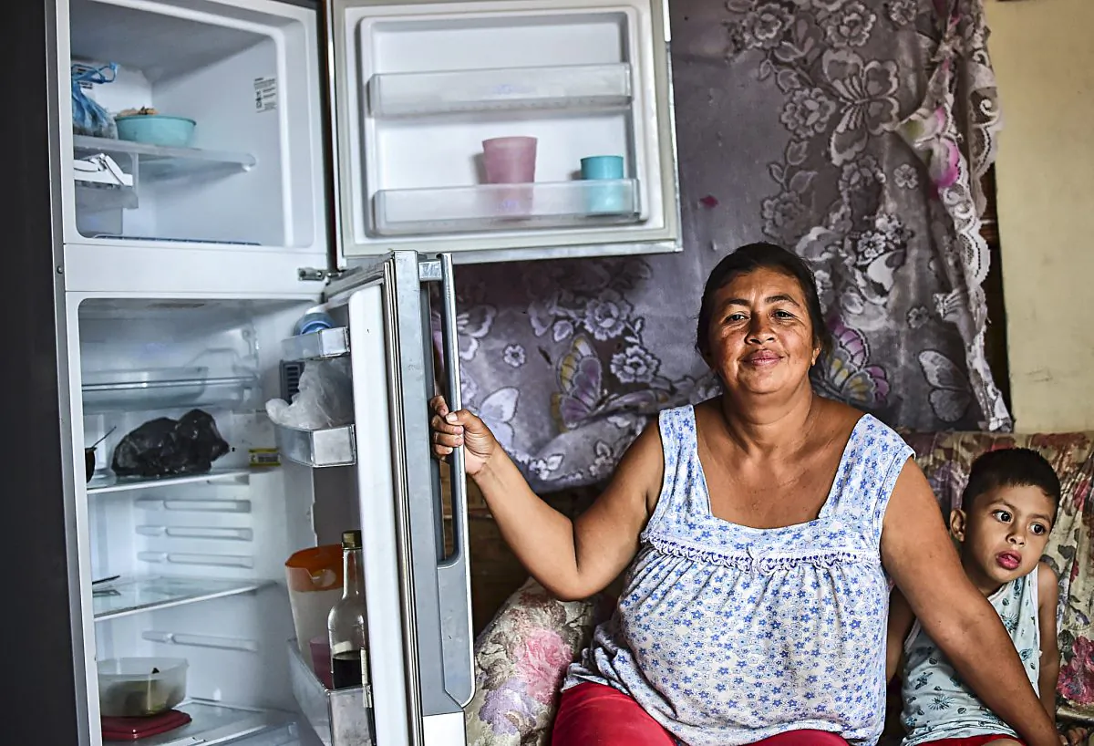 A woman shows her empty refrigerator at her home in Caracas, Venezuela, on June 2. Many Venezuelans are unable to buy enough food. (RONALDO SCHEMIDT/AFP/Getty Images)