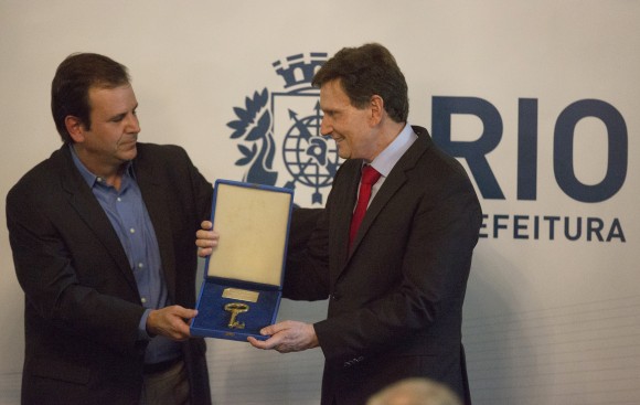 Evangelical bishop and senator Marcelo Crivella, right, receives the key of the city from the former mayor Eduardo Paes during his inauguration ceremony in Rio de Janeiro, Brazil on Jan. 1, 2017. (AP Photo/Leo Correa)