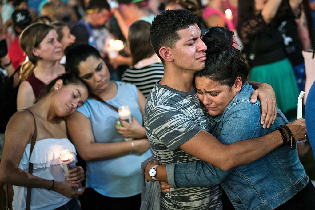 People embrace during a vigil outside the Dr. Phillips Center for the Performing Arts for the mass shooting victims at the Pulse nightclub June 13, 2016 in Orlando, Florida. The American gunman who launched a murderous assault on a gay nightclub in Orlando was radicalized by Islamist propaganda, officials said Monday, as they grappled with the worst terror attack on US soil since 9/11.   / AFP / Brendan Smialowski        (Photo credit should read BRENDAN SMIALOWSKI/AFP/Getty Images)