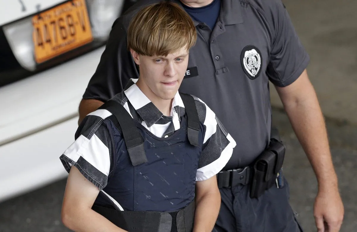 Shooting suspect Dylann Storm Roof is escorted from the Cleveland County Courthouse in Shelby, N.C., In this file photo. (AP Photo/Chuck Burton)