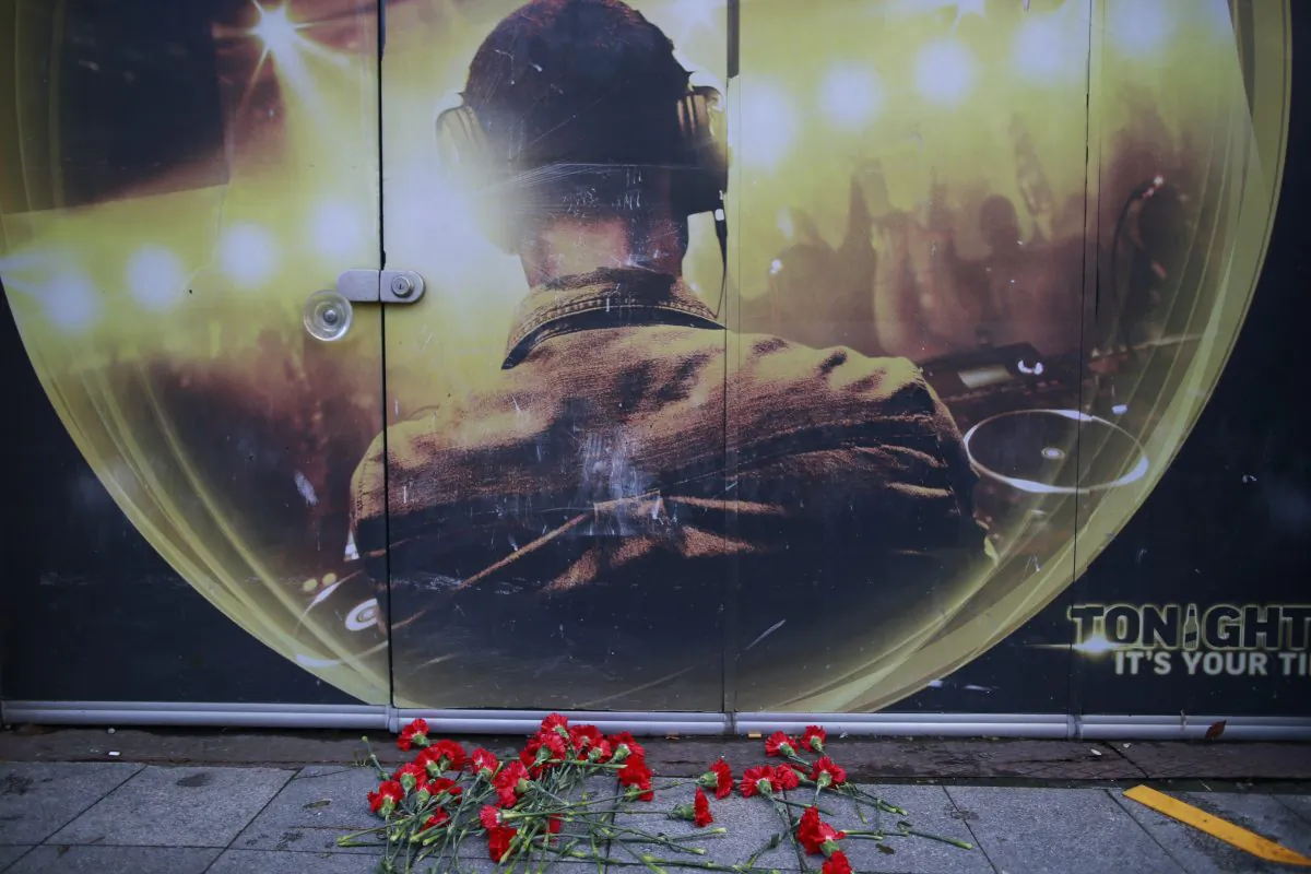Flowers of the victims of the attack are placed outside a nightclub, which was attacked by a gunman overnight, in Istanbul, on New Year's Day, Sunday, Jan. 1, 2017. An assailant believed to have been dressed in a Santa Claus costume and armed with a long-barrelled weapon, opened fire at the nightclub in Istanbul's Ortakoy district during New Year's celebrations, killing dozens of people and wounding dozens of others in what the province's governor described as a terror attack. (AP Photo/Emrah Gurel)