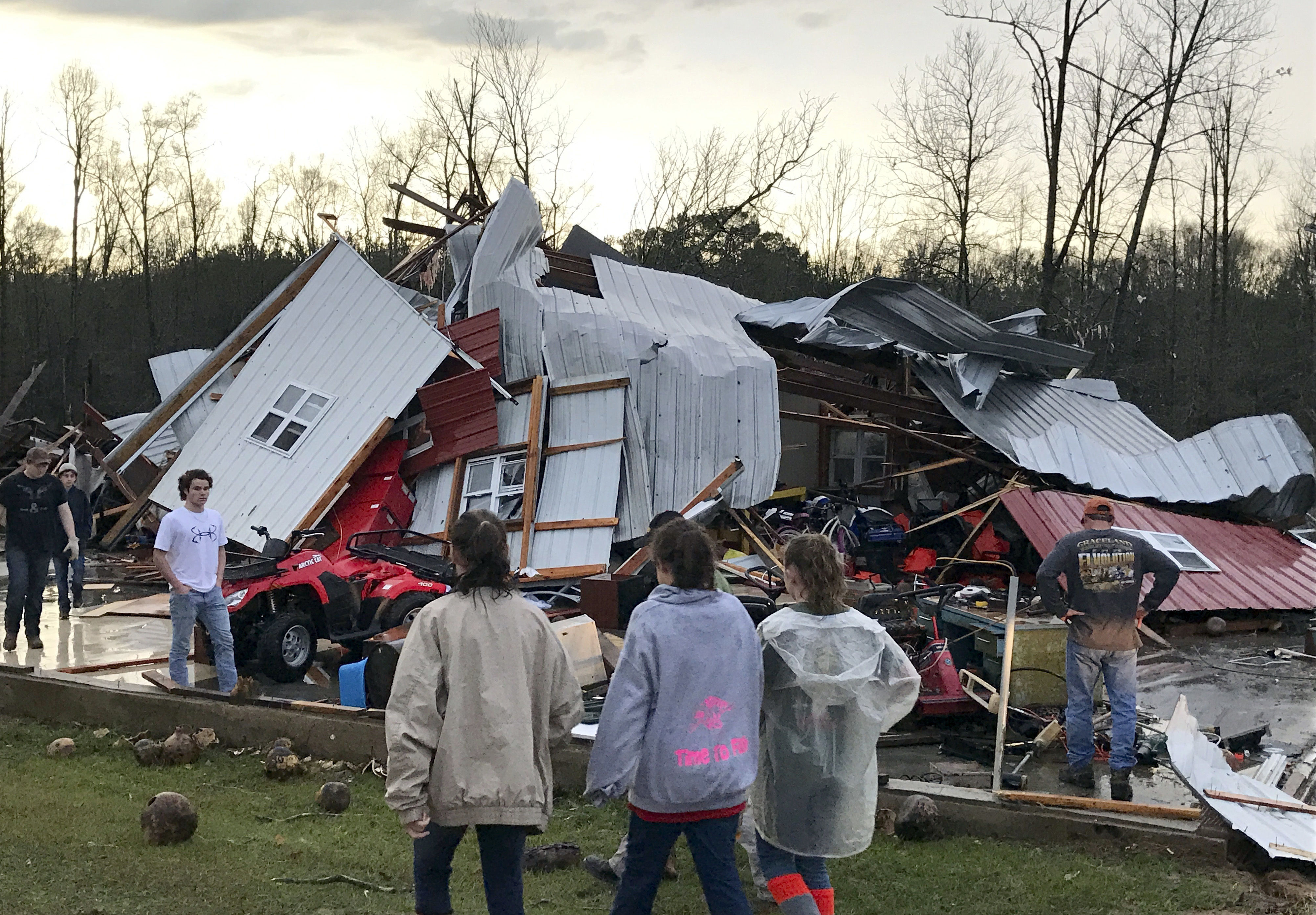 People examine a barn owned by the Miller family that was destroyed during a storm south of Mount Olive, Miss., on Jan. 2, 2017. (Ryan Moore/WDAM-TV via AP)