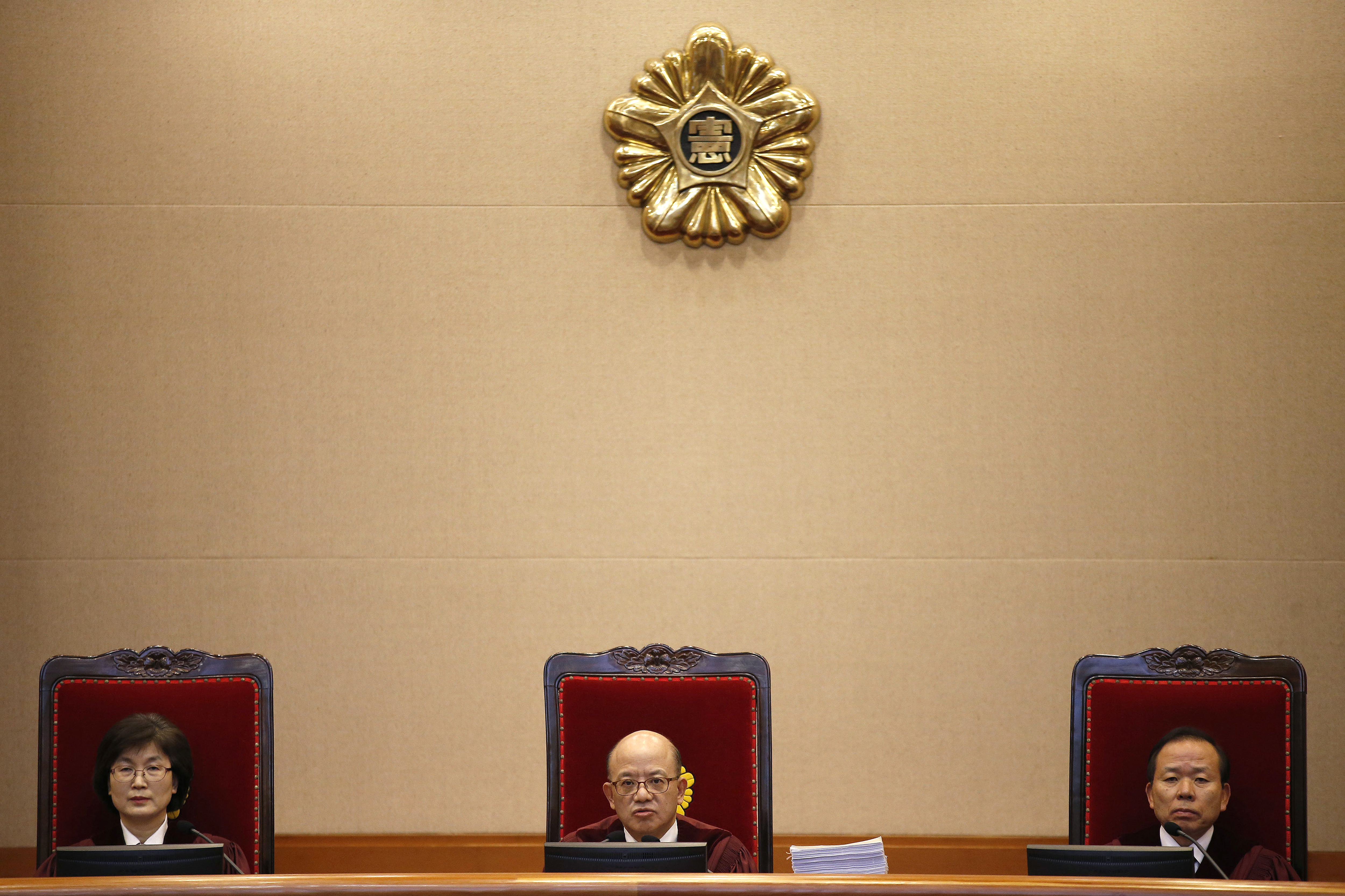 Chief Justice Park Han-chul, center, presides over the first hearing arguments for South Korean President Park Geun-hye's impeachment trial at the Constitutional Court in Seoul, South Korea, Tuesday, Jan 3, 2017. (Kim Hong-Ji/Pool Photo via AP)