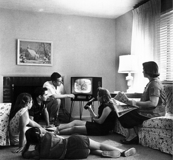 A family huddles around the television in the late 1950s.  (National Archives and Records Administration/Evert F. Baumgardner [Public domain], via Wikimedia Commons)
