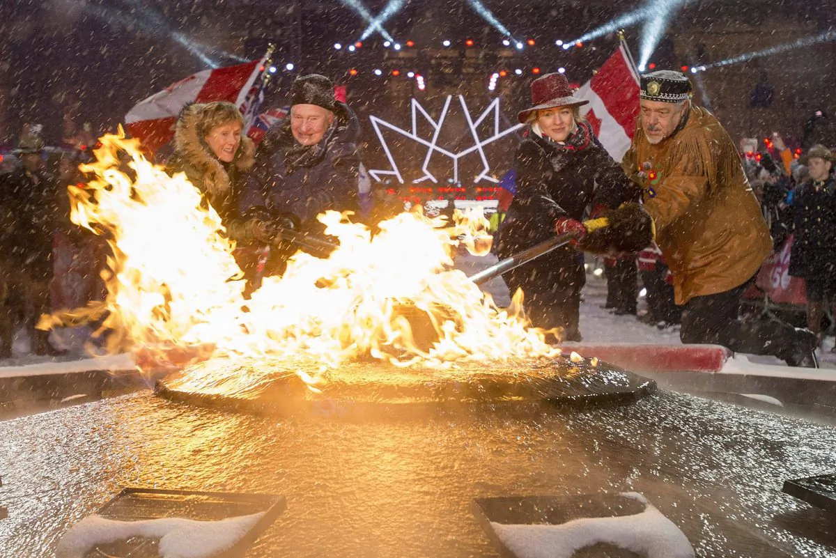 (L-R) Sharon Johnston, Gov. Gen. David Johnston, Minister of Canadian Heritage Melanie Joly, and Elder Albert Dumont re-light the Centennial Flame on Parliament Hill on New Year's Eve, Dec. 31, 2016, in Ottawa. Canada celebrates its 150th anniversary of Confederation in 2017. (The Canadian Press/Justin Tang)
