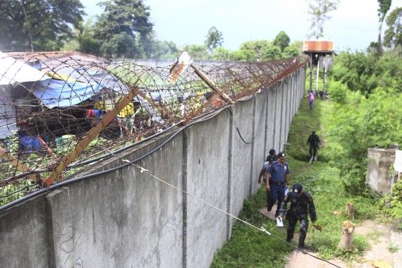 Policemen patrol outside the walls of the North Cotabato District Jail after a massive jailbreak in Kidapawan city, Cotabato Province, southern Philippines, on Jan. 4, 2017. (AP Photo)