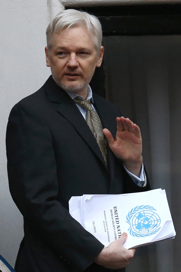 LONDON, ENGLAND - FEBRUARY 05: Wikileaks founder Julian Assange waves as he returns inside after speaking from the balcony of the Ecuadorian embassy where he continues to seek asylum following an extradition request from Sweden in 2012, on February 5, 2016 in London, England. The United Nations Working Group on Arbitrary Detention has insisted that Mr Assange's detention should be brought to an end. (Photo by Carl Court/Getty Images)