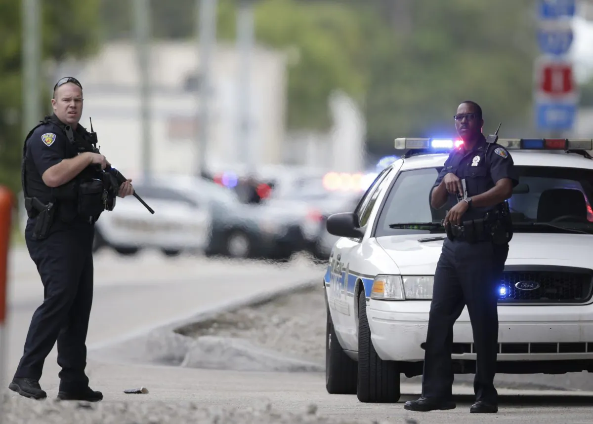 Police officers stand on a road along the Fort Lauderdale-Hollywood International Airport in Florida on Jan. 6, 2017. (Lynne Sladky/AP Photo)