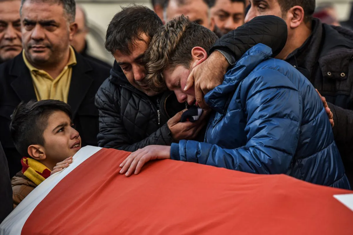Relatives and friends mourn at a coffin in Istanbul on Jan. 1, during the funeral of Ayhan Arik, one of the 39 victims of the gun attack on the Reina nightclub. (OZAN KOSE/AFP/Getty Images)