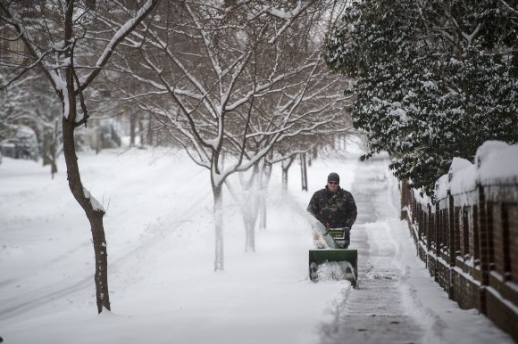 Daniel Mitchell operates a snowblower along the sidewalk on Norfolk Ave. next to Randolph College in Lynchburg, Va. on Jan. 7, 2017. (Jay Westcott /News & Daily Advance via AP)