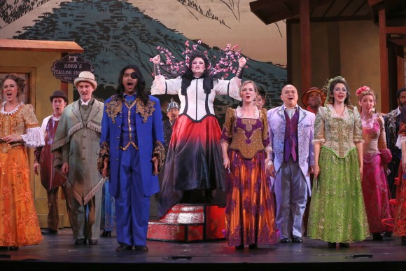Cáitlín Burke as Katisha (Center) and company in the first act finale. (Carol Rosegg)