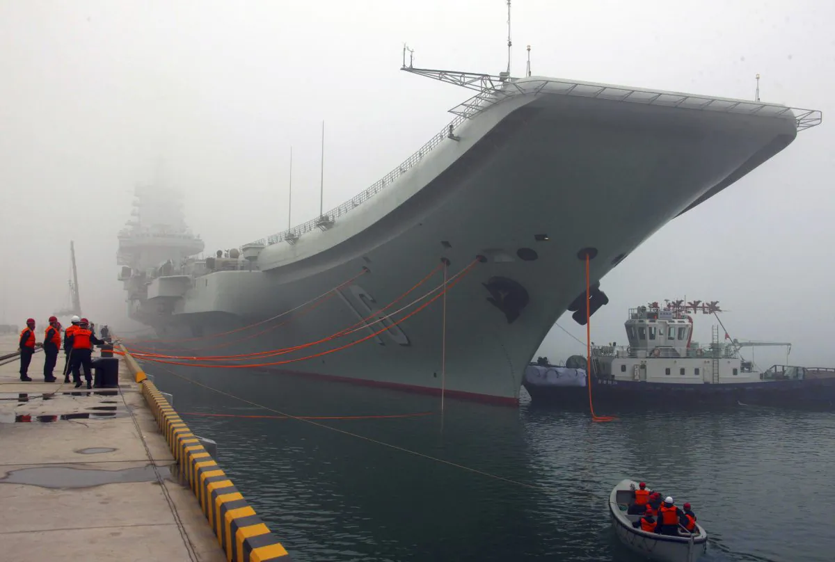 Chinese regime's first aircraft carrier, the Liaoning, is anchored in the northern port in Qingdao, east China's Shandong Province, on Feb. 27, 2013. (Wu Dengfeng/file/Xinhua via AP)