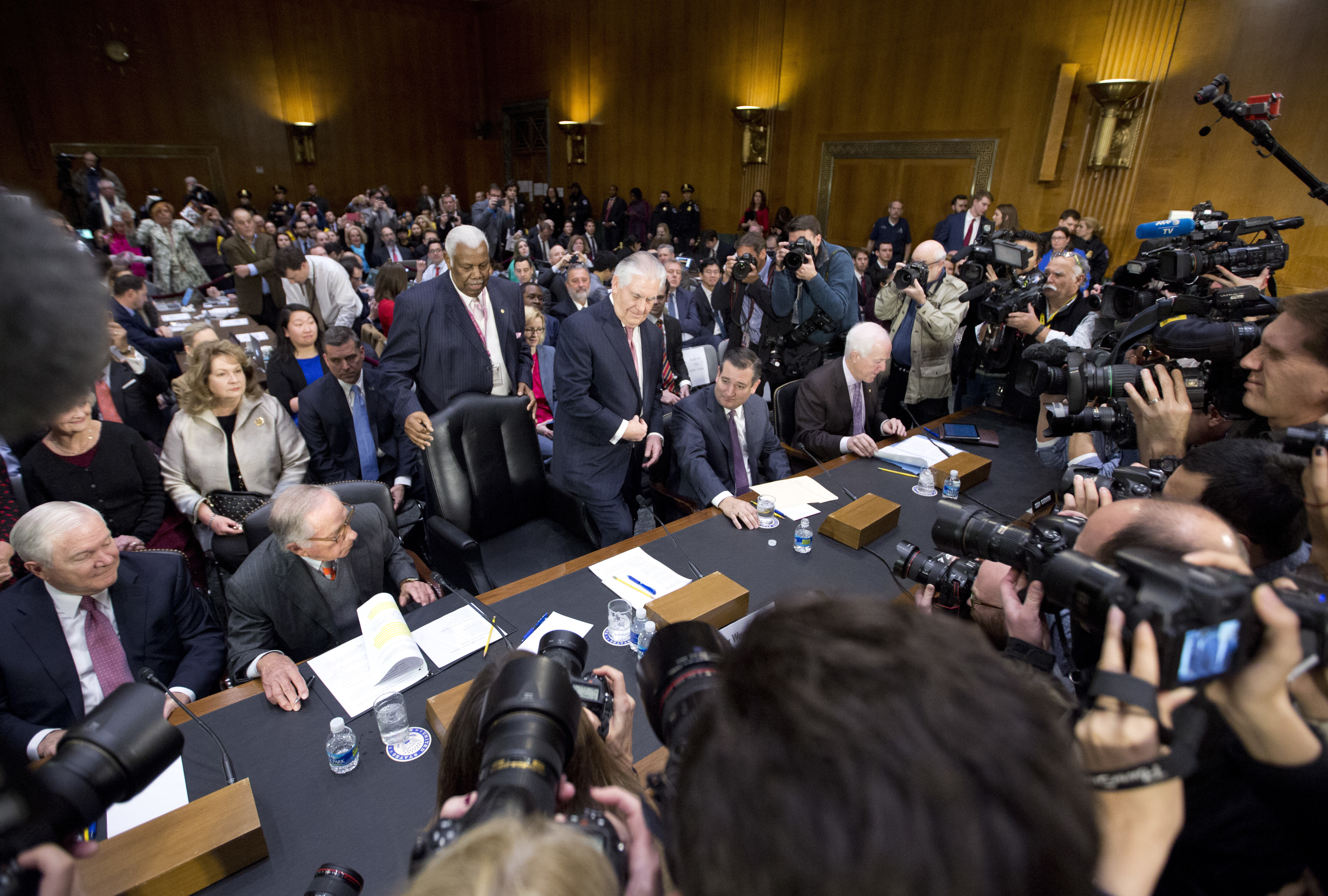 Secretary of State-designate Rex Tillerson (C) accompanied by (L-R) former Defense Secretary Robert Gates, former Georgia Sen. San Nunn, Sen. Ted Cruz, R-Texas, and Senate Majority Whip John Cornyn of Texas, takes his seat on Capitol Hill in Washington on Jan. 11, 2017. (AP Photo/Steve Helber)