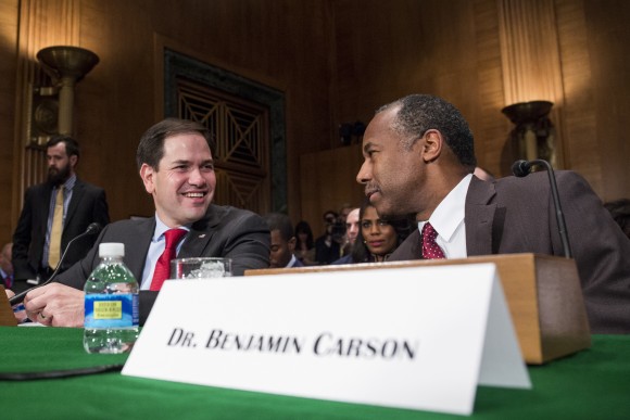 Housing and Urban Development Secretary-designate Ben Carson speaks to Sen. Marco Rubio, R-Fla. on Capitol Hill in Washington, Thursday, Jan. 12, 2017, prior to the start of Carson's confirmation hearing before the Senate Banking, Housing, and Urban Affairs Committee. (AP Photo/Zach Gibson)