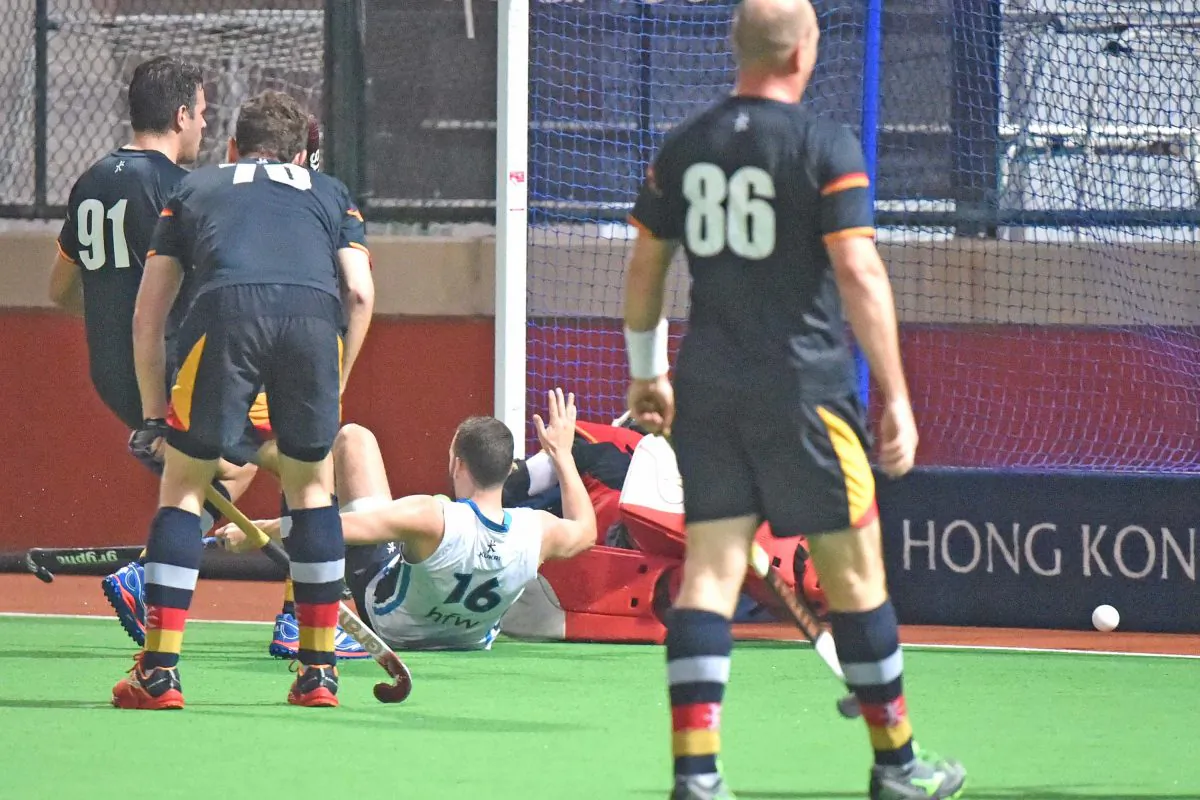 Thomas Moore deflects a ball from Ishtiaq Ahmed past the HKCC-A keeper to make the score 3-0 in their HKHA Premier Division Match at HKFC on Sunday Jan 8. The final result was 4-0 to HKFC. (Bill Cox/Epoch Times)