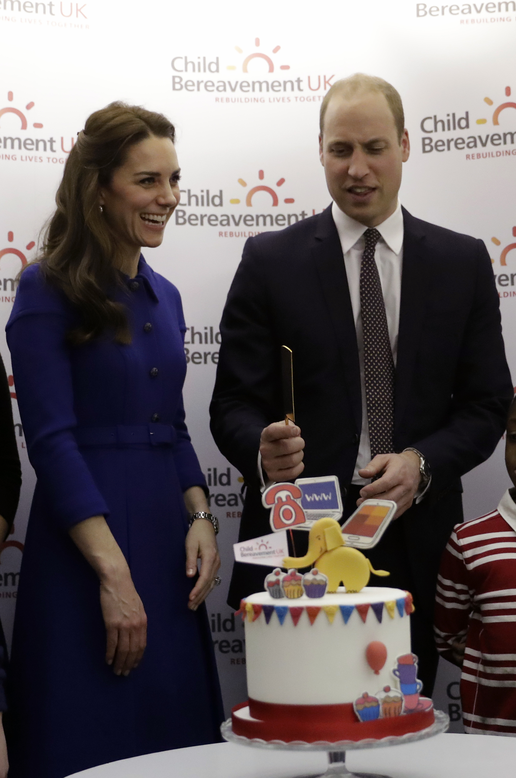 Britain's Prince William and his wife Kate the Duchess of Cambridge prepare to cut a cake to celebrate the one year anniversary of this charity's branch, during their visit to a Child Bereavement UK Centre in Stratford in east London on Jan. 11, 2017. (AP Photo/Matt Dunham, Pool)