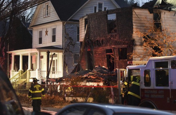 Baltimore City firefighters remain on the scene early Thursday, Jan. 12, 2017, after a fire on Springwood Avenue in northeast Baltimore. Several children and an adult were taken to an area hospital. Six children are still missing. (Jerry Jackson/The Baltimore Sun via AP)