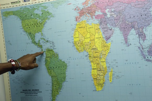 Cuban migrant Ulises Ferrer, 39, points out his route to the U.S., during his stay at a shelter in Panama City on Jan. 12, 2017. (AP Photo/Arnulfo Franco)