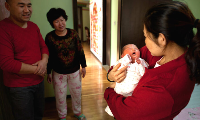 A woman holds a newborn girl at the Antai maternity hospital in Beijing on Jan. 26, 2012. (Ed Jones/AFP/Getty Images)