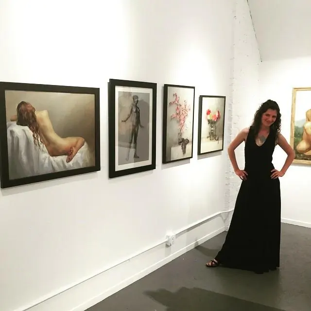 Mandy Hallenius in front of her paintings at an exhibit. (Courtesy of Mandy Hallenius)