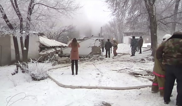 Rescuers and people watch at a plane crash site outside Bishkek, Kyrgyzstan, on Jan. 16, 2017. (AP Photo)